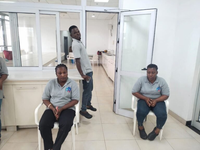 Dromo team squeegeeing and mopping a large tiled room during a deep clean