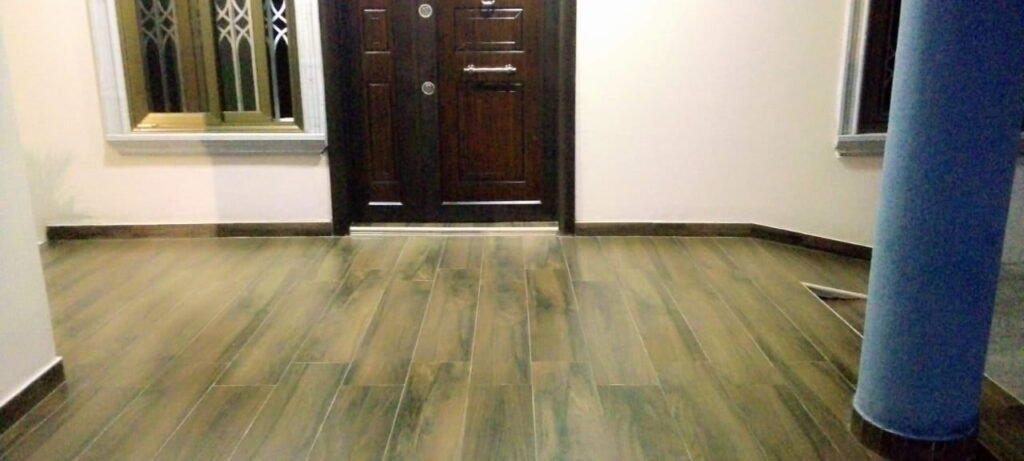 Dromo team using a floor polishing machine in a bright living room