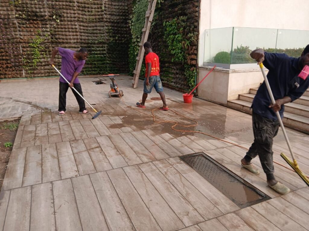 Dromo team scrubbing an outdoor tiled terrace