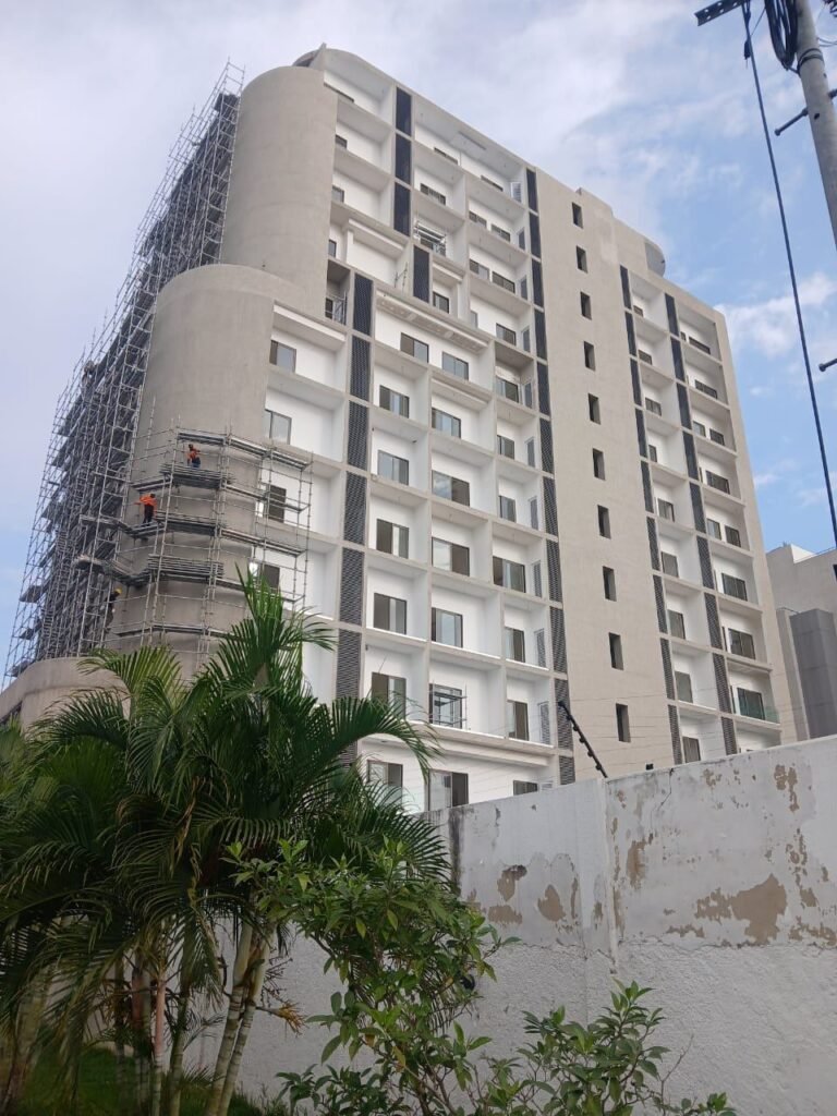 High-rise building under scaffolding during post-construction cleaning in Accra