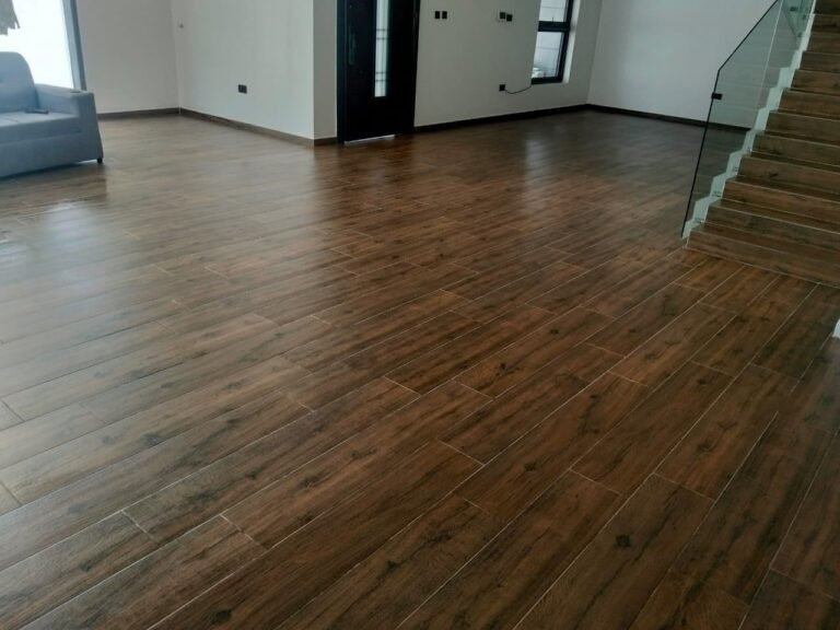 Clean, polished wood-effect tile floor in an open-plan room after a Dromo deep clean